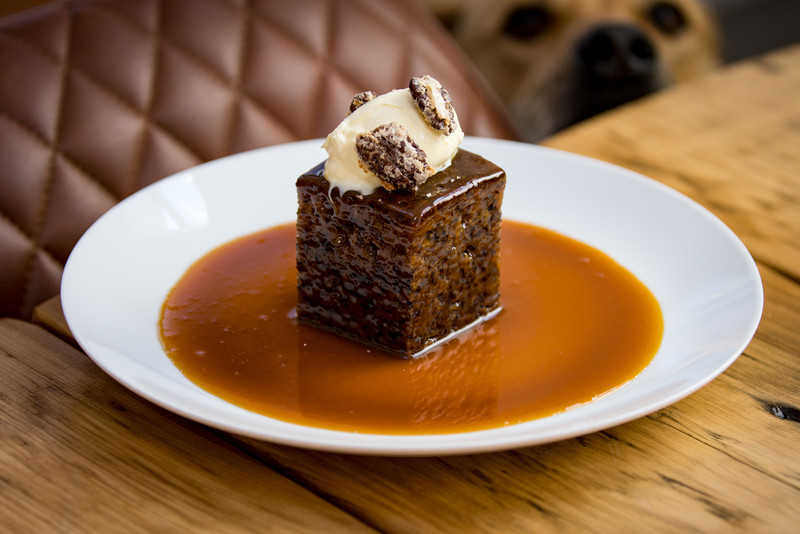 Banana cake with butterscotch sauce, candied pecans and clotted cream